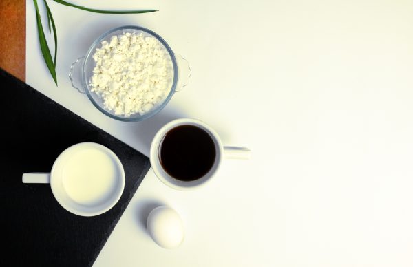 Natural products for breakfast: cottage cheese, egg, kefir, black coffee