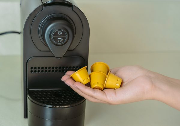 woman hand holding many coffee capsules on palm